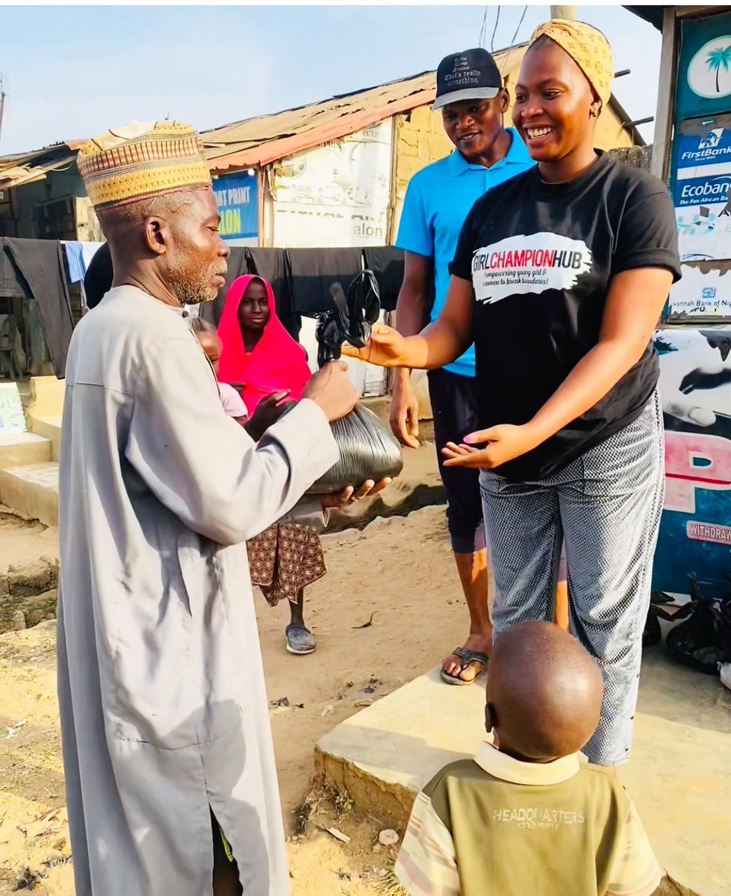 Team member with community elder and child