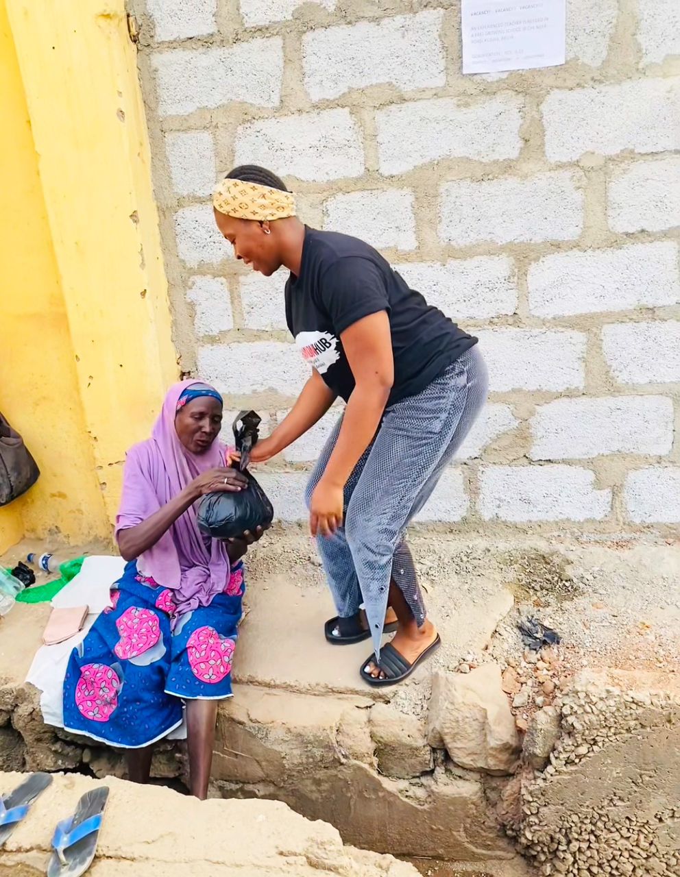Woman distributing pads to community