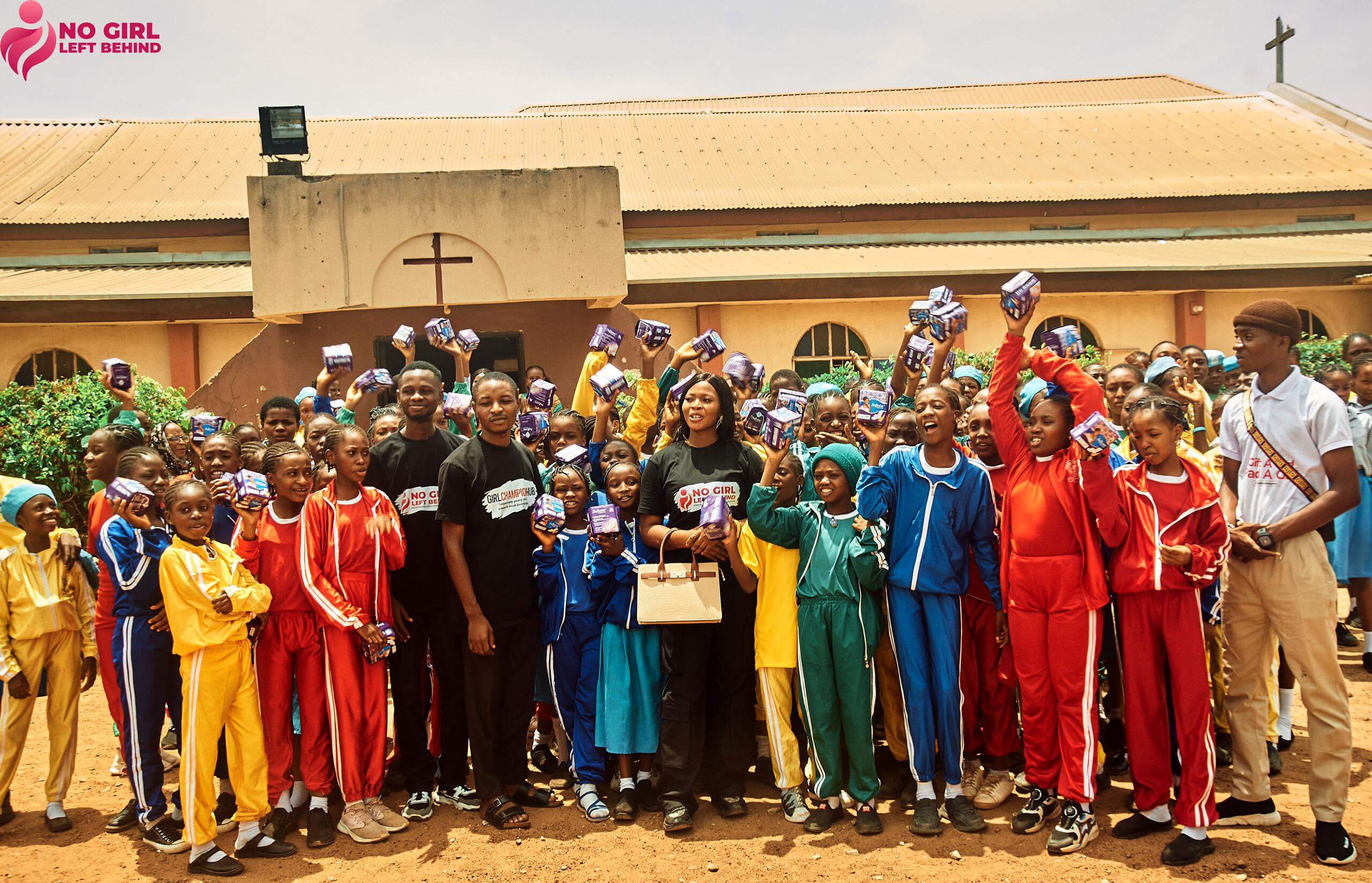 Team with girls holding pads at school